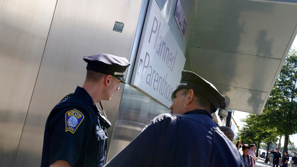 Boston police officers stand in front of a Planned Parenthood clinic in Boston