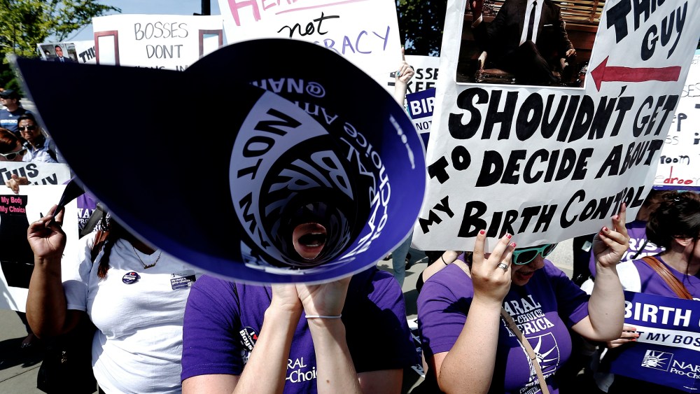 Demonstrators in support of abortion and contraceptive rights chant in suport of their cause after the Hobby Lobby ruling outside the U.S. Supreme Court in Washington