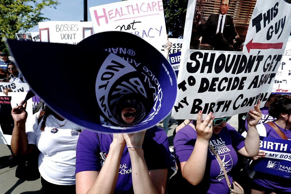 Demonstrators in support of abortion and contraceptive rights chant in suport of their cause after the Hobby Lobby ruling outside the U.S. Supreme Court in Washington