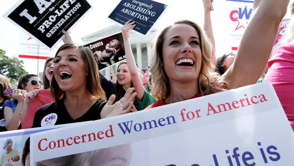 Demonstrators cheer as the ruling for Hobby Lobby was announced outside the U.S. Supreme Court in Washington