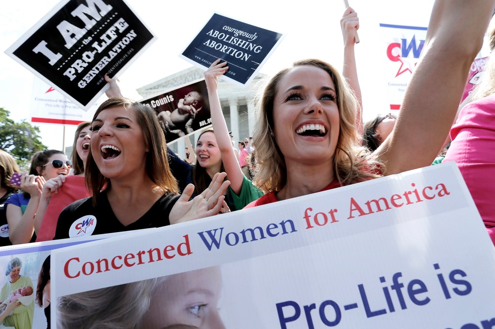 Demonstrators cheer as the ruling for Hobby Lobby was announced outside the U.S. Supreme Court in Washington