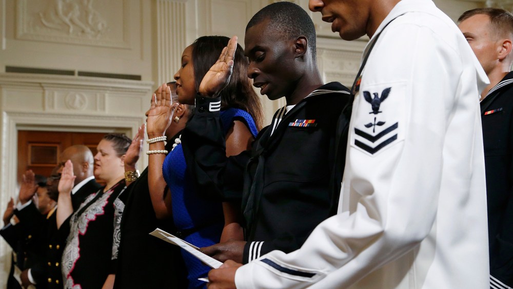 Members of the U.S. military and military spouses recite the Oath of Allegiance to become naturalized U.S. citizens during a ceremony hosted by U.S. President Barack Obama (not pictured) at the White House in Washington July 4, 2014.