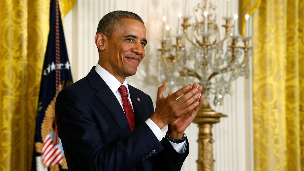 U.S. President Barack Obama applauds new U.S. citizens after they took the Oath of Allegiance at a naturalization ceremony for active duty service members and civilians at the White House in Washington July 4, 2014.