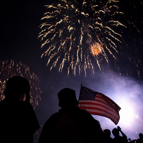 Spectators watch Macy's Fourth of July fireworks explode over the East River in New York July 4, 2014. (Photo by Eric Thayer/Reuters)