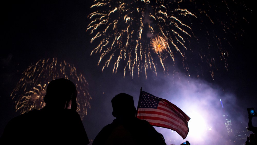 Spectators watch Macy's Fourth of July fireworks explode over the East River in New York July 4, 2014. (Photo by Eric Thayer/Reuters)