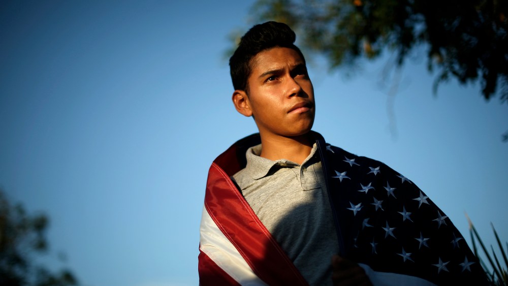 William Bello, 16, listens to speakers at a vigil in support of refugee children and their families in Murrieta, Calif. on July 9, 2014.