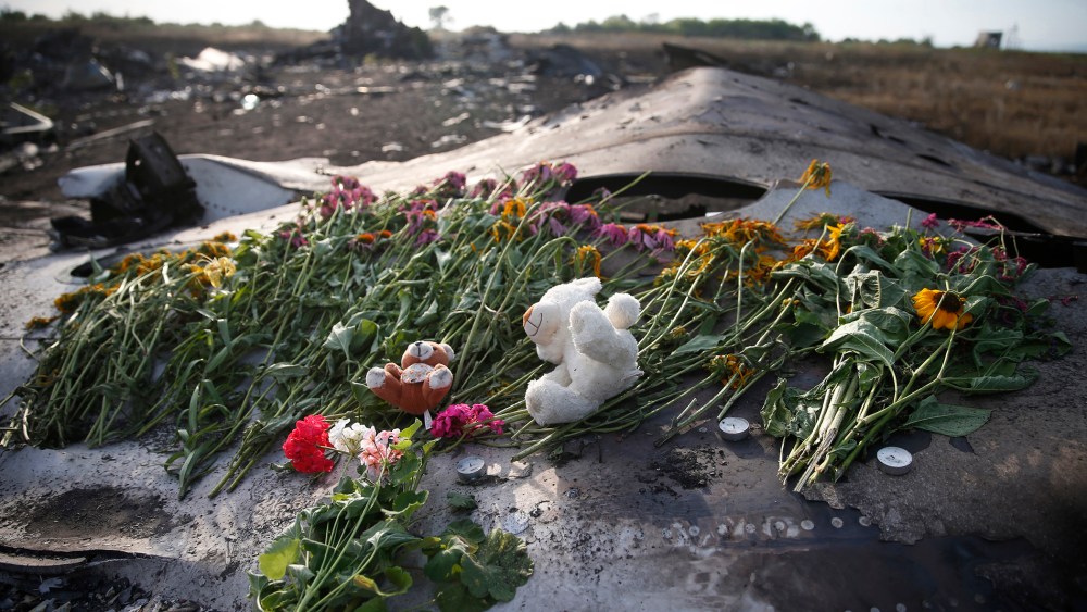 Flowers and mementos lie on wreckage at the crash site of Malaysia Airlines Flight MH17, near the settlement of Grabovo in the Donetsk region of Ukraine, July 19, 2014.