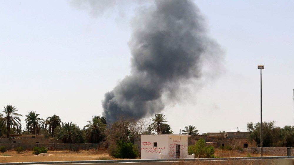 Smoke rises over the Airport Road area after heavy fighting between rival militias broke out near the airport in Tripoli July 25, 2014.