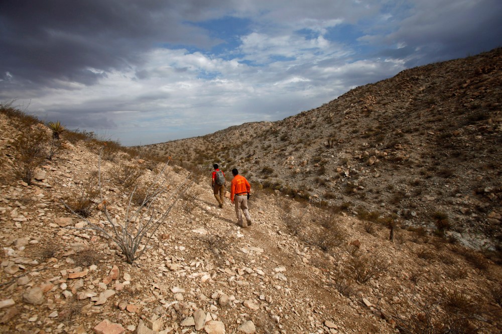 Members of Mexican immigrant welfare agency Grupo Beta search in the mountains between Mexico and the U.S. for potential border crossers during a patrol on the outskirts of Ciudad Juarez, July 29, 2014. (Photo by Jose Luis Gonzalez/Reuters)