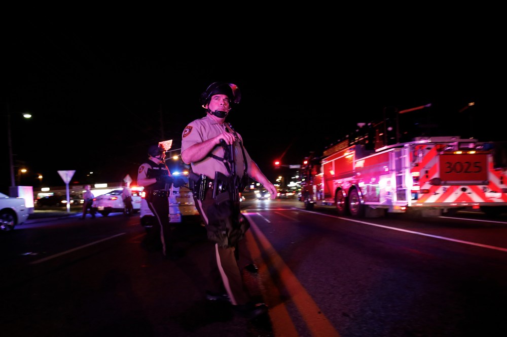 Police officers patrol a street in Ferguson