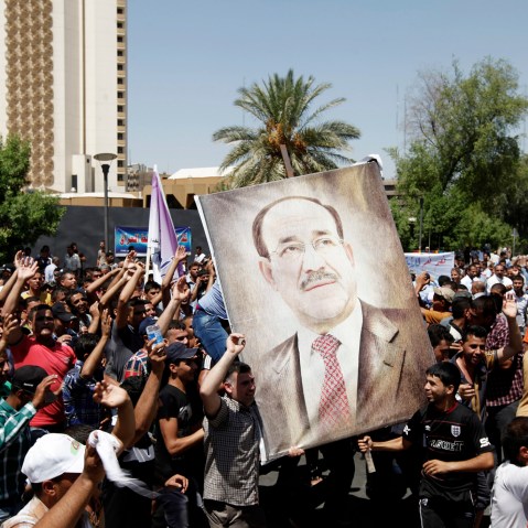 People carry portraits of Nuri al-Maliki as they gather in support of him in Baghdad on Aug. 13, 2014.