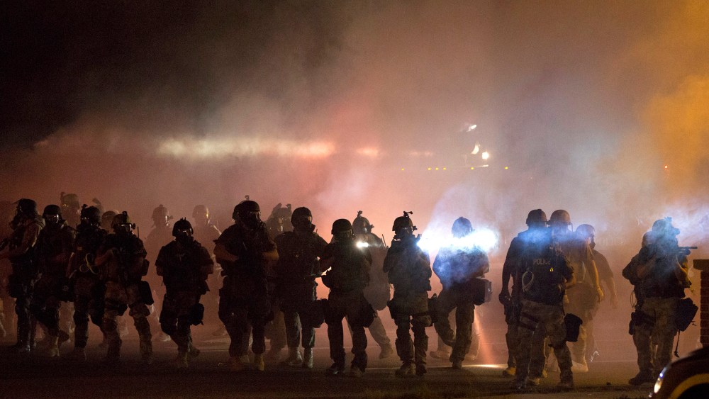 Riot police clear demonstrators from a street in Ferguson, Mo., Aug. 13, 2014. (Photo by Mario Anzuoni/Reuters)