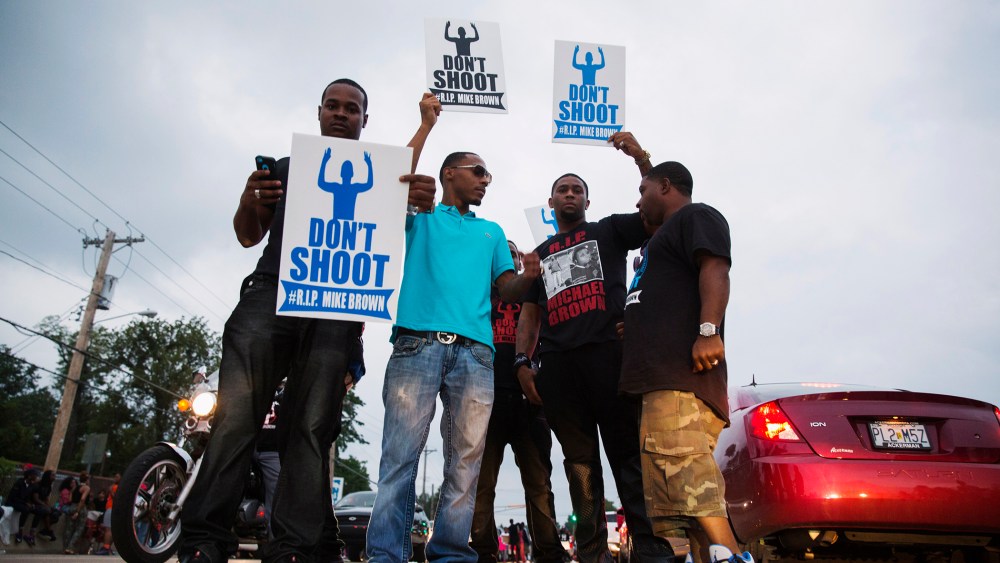 Demonstrators gesture and chant as they continue to react to the shooting of Michael Brown in Ferguson, Missouri August 17, 2014.