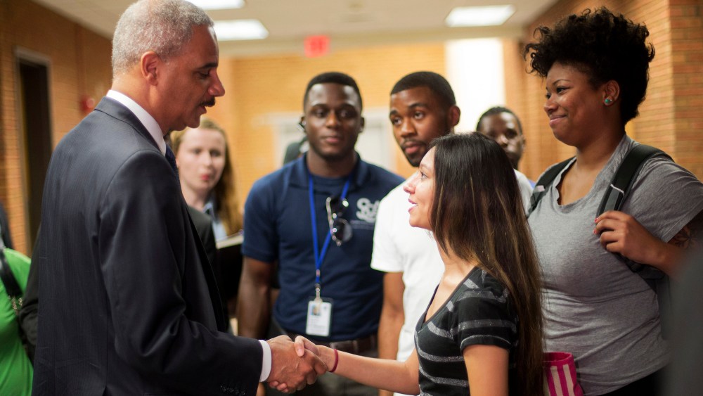 Attorney General Eric Holder shakes hands with Bri Ehsan, 25, following his meeting with students at St. Louis Community College Florissant Valley in Ferguson, Missouri August 20, 2014.