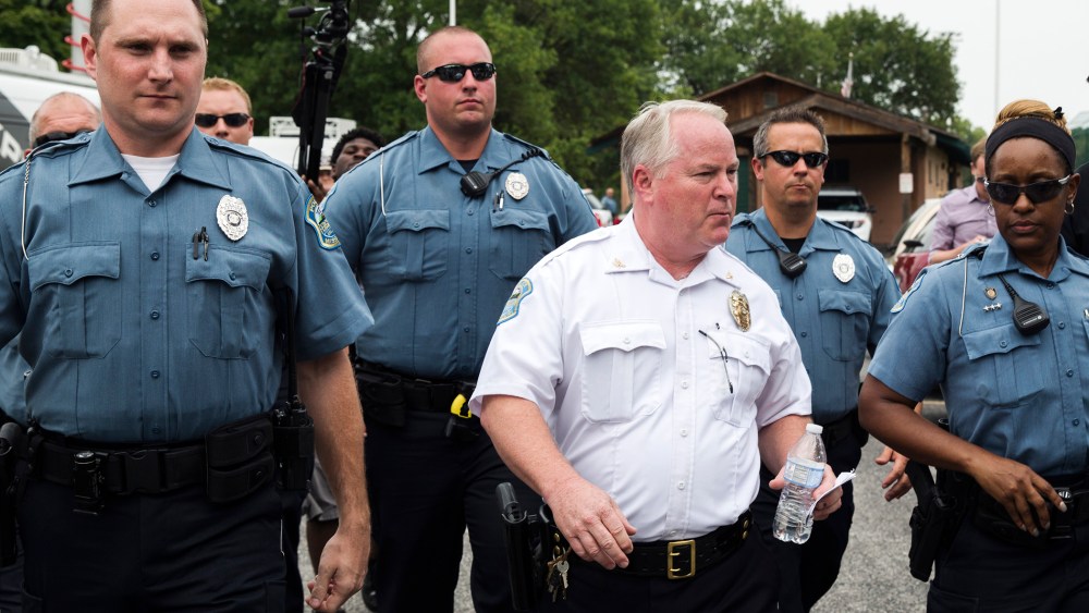 Ferguson Police Chief Thomas Jackson (C) walks away from a media availability in Ferguson, Mo on Aug. 15, 2014. (Photo by Lucas Jackson/Reuters)