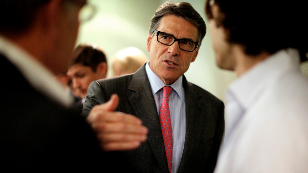 Texas Governor Perry, a possible Republican candidate for 2016 presidential race, talks several participants at business leaders luncheon in Portsmouth