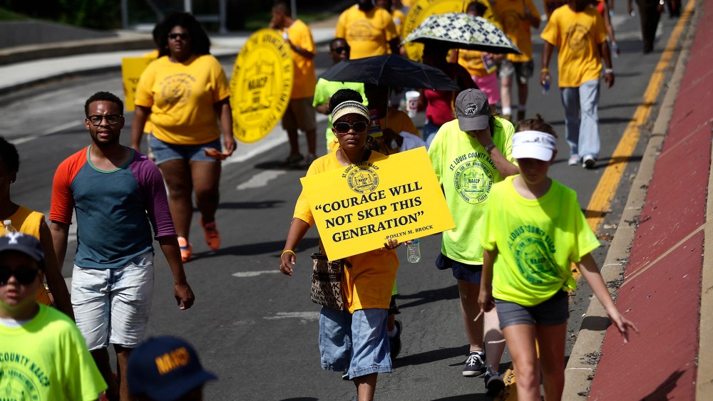Demonstrators protest the shooting of Michael Brown in Ferguson, Mo., Aug. 23, 2014.