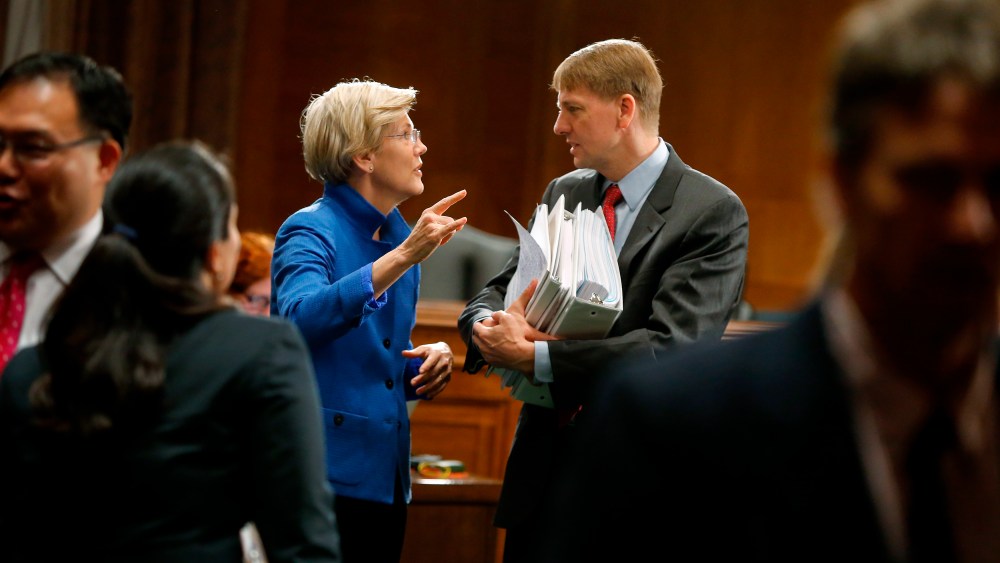 U.S. Senator Warren talks with U.S. Consumer Financial Protection Bureau Director Cordray after he testified about Wall Street reform before a Senate Banking Committee hearing on Capitol Hill in Washington