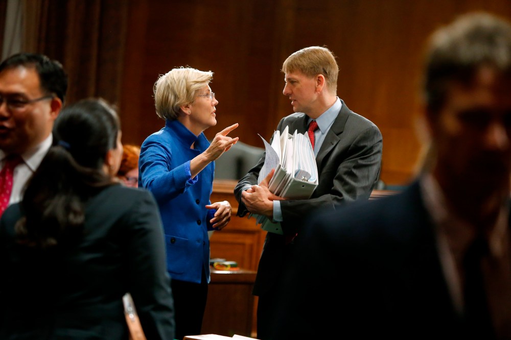 U.S. Senator Warren talks with U.S. Consumer Financial Protection Bureau Director Cordray after he testified about Wall Street reform before a Senate Banking Committee hearing on Capitol Hill in Washington