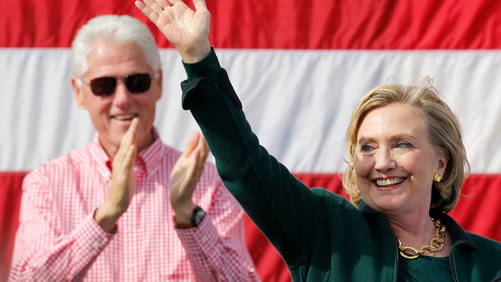 Former U.S. Secretary of State Hillary Clinton is applauded by her husband former U.S. President Bill Clinton at the 37th Harkin Steak Fry in Indianola, Iowa, Sept. 14, 2014.