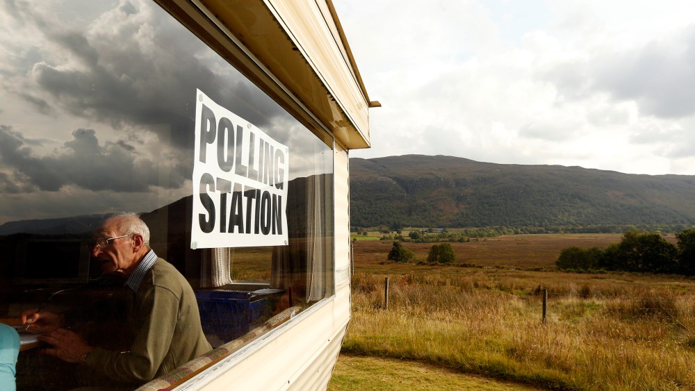 Poll clerk George MacKay sits in the Coulags caravan polling station, in the Scottish Highlands Sept. 18, 2014.