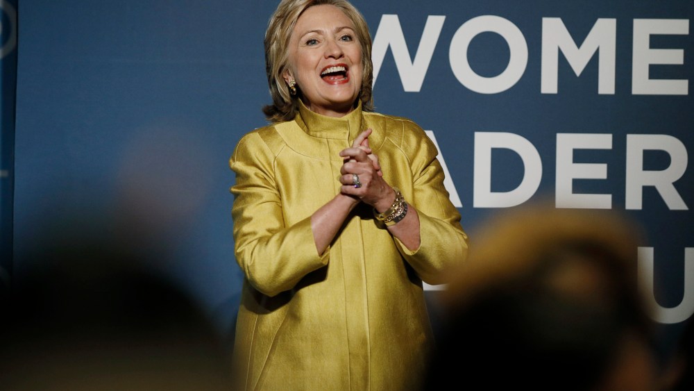 Former U.S. Secretary of State Clinton reacts to the cheers of the crowd as she arrives to address the DNC Women?s Leadership Forum?s annual Issues Conference in Washington
