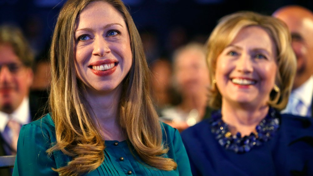 Former U.S. Secretary of State Hillary Clinton and her daughter Chelsea Clinton listen as U.S. President Barack Obama speaks at the Clinton Global Initiative in New York, Sep. 23, 2014. (Photo by Kevin Lamarque/Reuters)