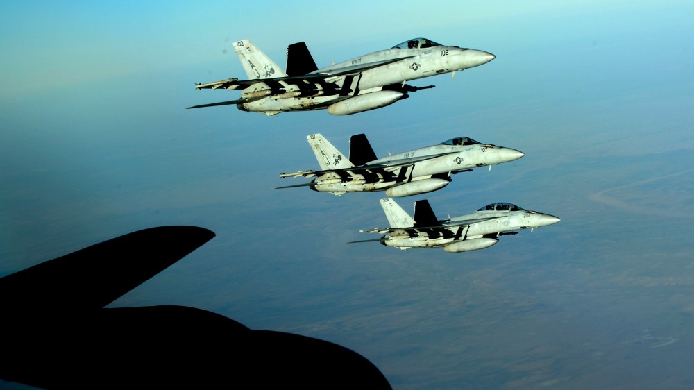 A formation of U.S. Navy F-18E Super Hornets leaves after receiving fuel from a KC-135 Stratotanker over northern Iraq on Sept. 23, 2014.