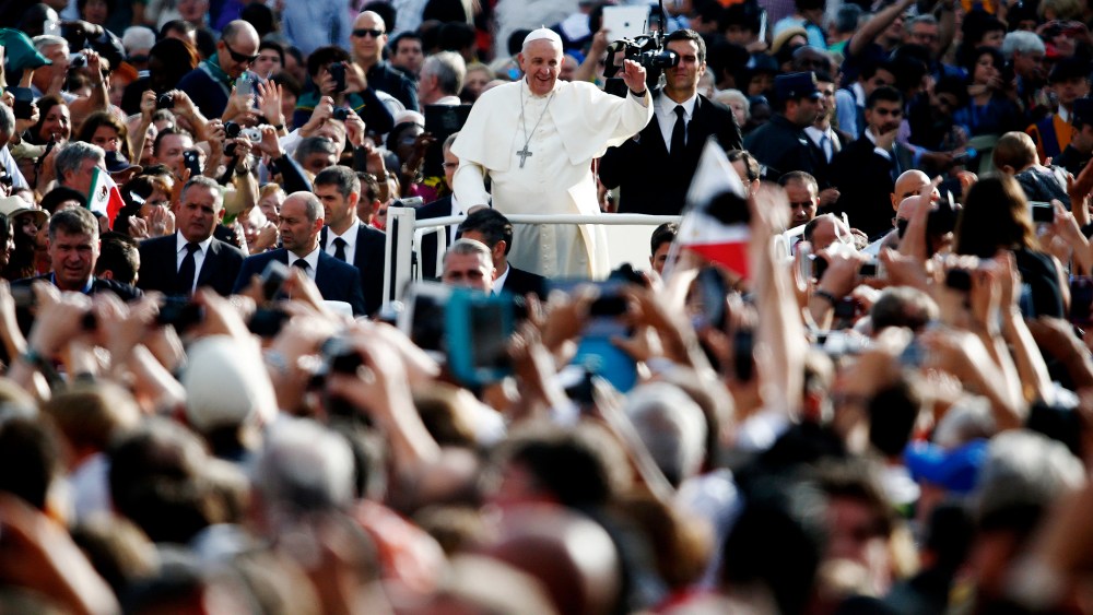 Pope Francis waves as he leads his weekly audience in Saint Peter's Square at the Vatican on Oct. 1, 2014. (Photo by Tony Gentile/Reuters)
