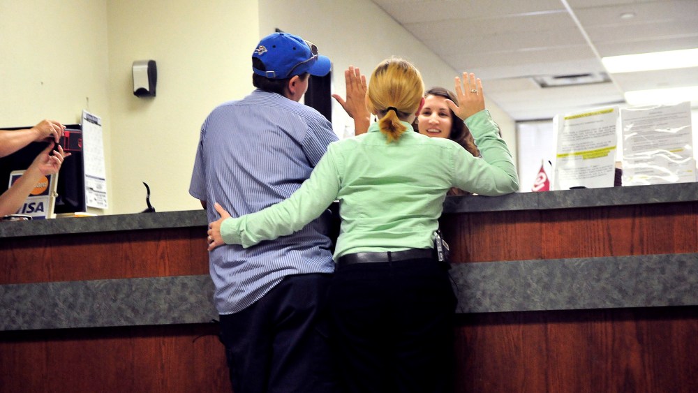 Jennifer Hasler (L) and Karina Tittjung take an oath to receive their marriage license at the Oklahoma County courthouse in Oklahoma City, Oklahoma on Oct. 6, 2014.