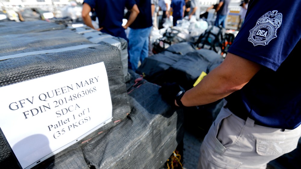 Drug Enforcement Agency (DEA) agents take inventory of seized cocaine packages, on the deck of the US Coast Guard Cutter Boutwell at Naval Base San Diego in San Diego, Oct. 6, 2014. (Photo by Mike Blake/Reuters)