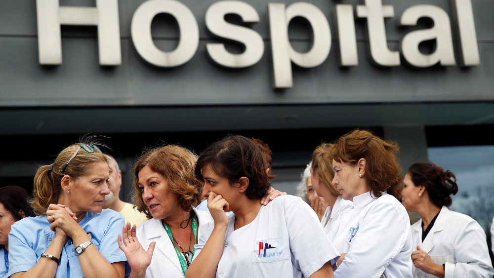 Health workers attend a protest outside La Paz Hospital calling for Spain's Health Minister Ana Mato to resign after a Spanish nurse contracted Ebola, in Madrid, October 7, 2014.