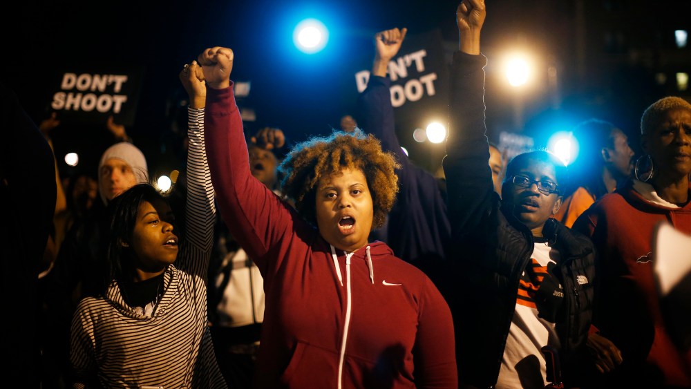 Protesters cheer after blocking an intersection after a vigil in St. Louis, Mo. on Oct. 9, 2014. (Photo by Jim Young/Reuters)