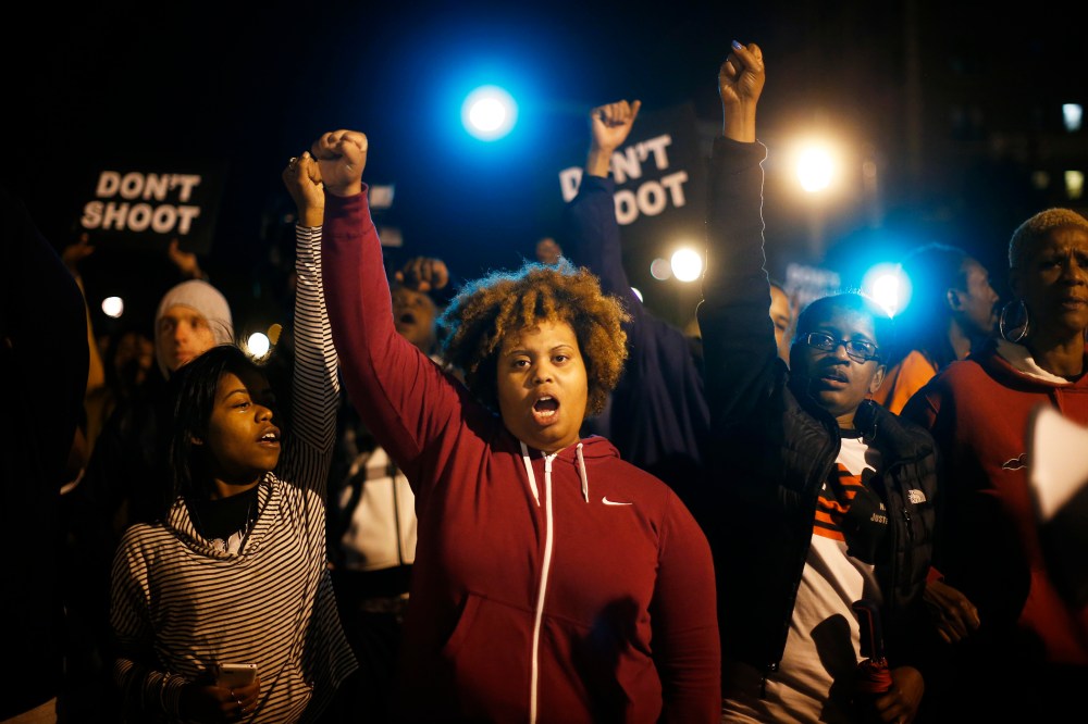 Protesters cheer after blocking an intersection after a vigil in St. Louis, Mo. on Oct. 9, 2014. (Photo by Jim Young/Reuters)