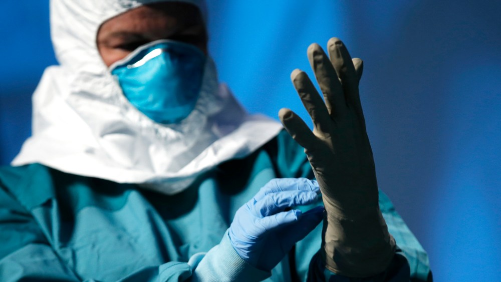 A registered nurse in New York, demonstrates putting on personal protective equipment (PPE) during an Ebola educational session for healthcare workers in New York, Oct. 21, 2014. (Photo by Mike Segar/Reuters)