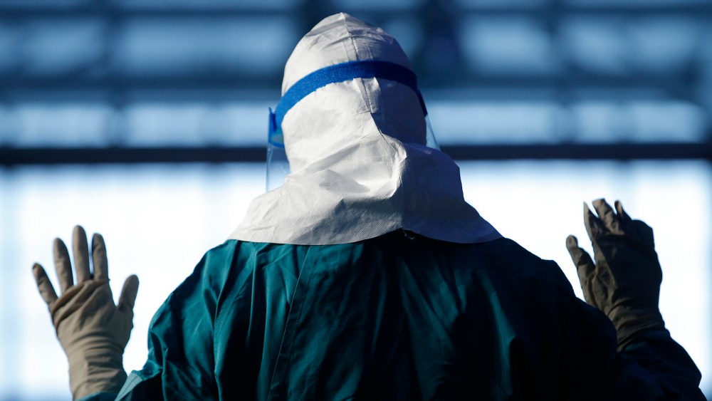 Barbara Smith, a registered nurse with Mount Sinai Medical Health Systems, St. Luke's and Roosevelt Hospitals in New York, demonstrates putting on personal protective equipment (PPE) during an Ebola educational session for healthcare workers at the Jacob