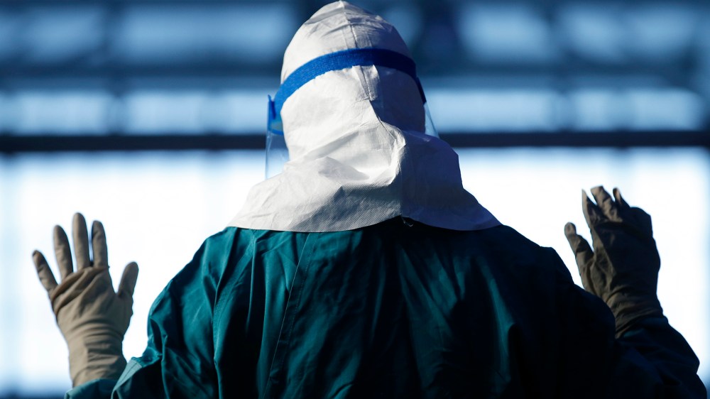 A registered nurse demonstrates putting on personal protective equipment (PPE) during an Ebola educational session for healthcare workers in New York in 2014. (Photo by Mike Segar/Reuters)