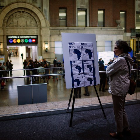 A woman reads alert on Ebola inside the Bellevue Hospital where Dr. Craig Spencer is being treated for Ebola symptoms in New York on Oct. 23, 2014.