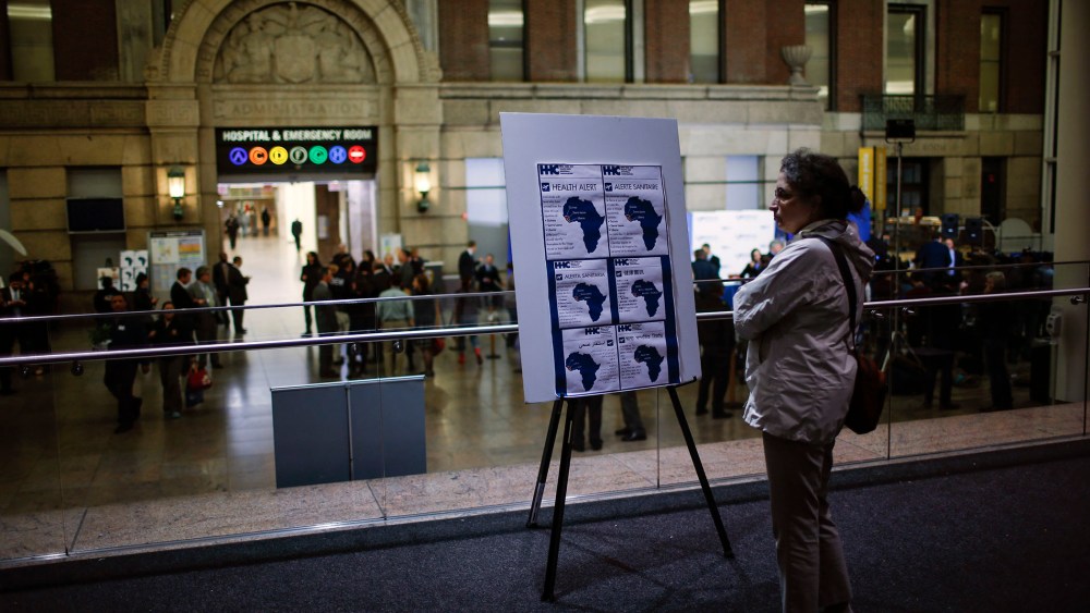 A woman reads alert on Ebola inside the Bellevue Hospital where Dr. Craig Spencer is being treated for Ebola symptoms in New York on Oct. 23, 2014.