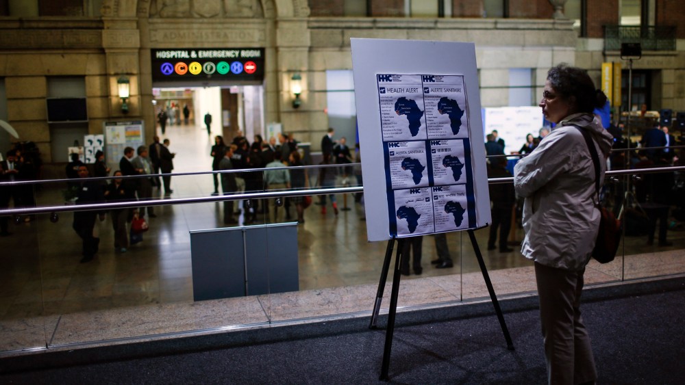 A woman reads alert on Ebola inside the Bellevue Hospital where Dr. Craig Spencer is being treated for Ebola symptoms in New York, N.Y., on Oct. 23, 2014. (Photo by Eduardo Munoz/Reuters)