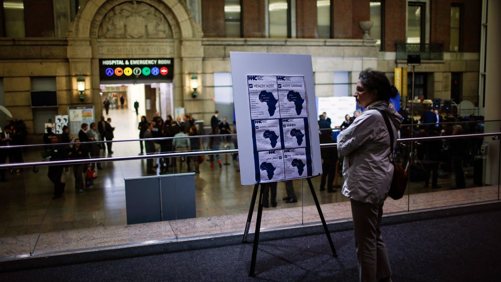 A woman reads alert on Ebola inside the Bellevue Hospital where Dr. Craig Spencer is being treated for Ebola symptoms in New York on Oct. 23, 2014. (Photo by Eduardo Munoz/Reuters)