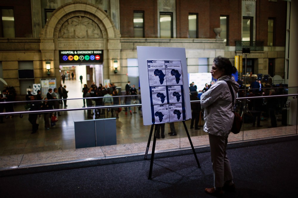 A woman reads alert on Ebola inside the Bellevue Hospital where Dr. Craig Spencer is being treated for Ebola symptoms in New York on Oct. 23, 2014. (Photo by Eduardo Munoz/Reuters)
