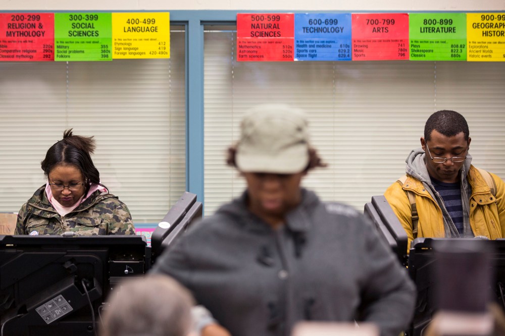 Voters cast their ballot in the U.S. midterm elections in Ferguson, Mo., Nov. 4, 2014. (Photo by Whitney Curtis/Reuters)