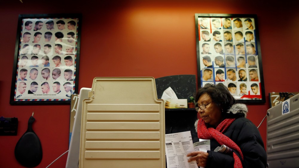 A voter casts her ballot for the U.S. midterm elections at a beauty salon used as a polling station in Chicago on Nov. 4, 2014