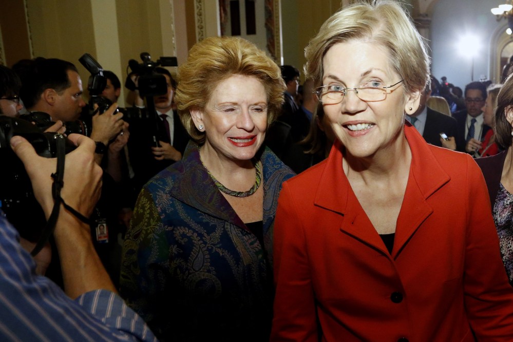 US Senator Elizabeth Warren, flanked by Senator Debbie Stabenow and Senator Amy Klobuchar leaves after speaking to reporters following a leadership election for the 114th Congress in Washington, Nov. 13, 2014. (Photo by Jonathan Ernst/Reuters)