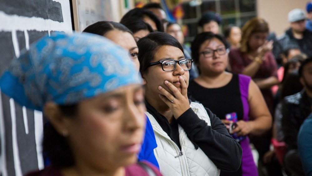 People watch U.S. President Barack Obama's national address in Phoenix