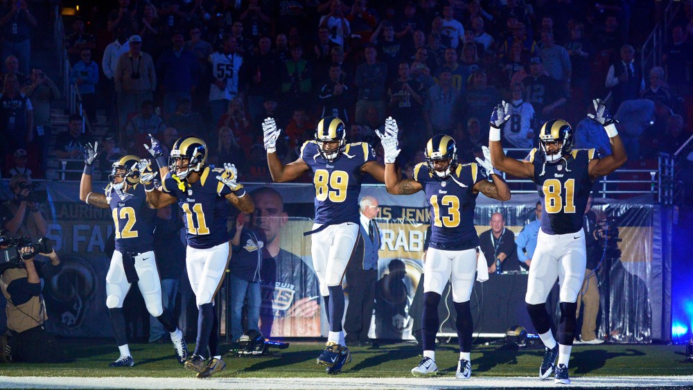 Players on the St. Louis Rams put their hands up to show support for Michael Brown before a game on Nov. 30, 2014 in St. Louis, Mo. (Photo by Jeff Curry/USA Today Sports/Reuters)