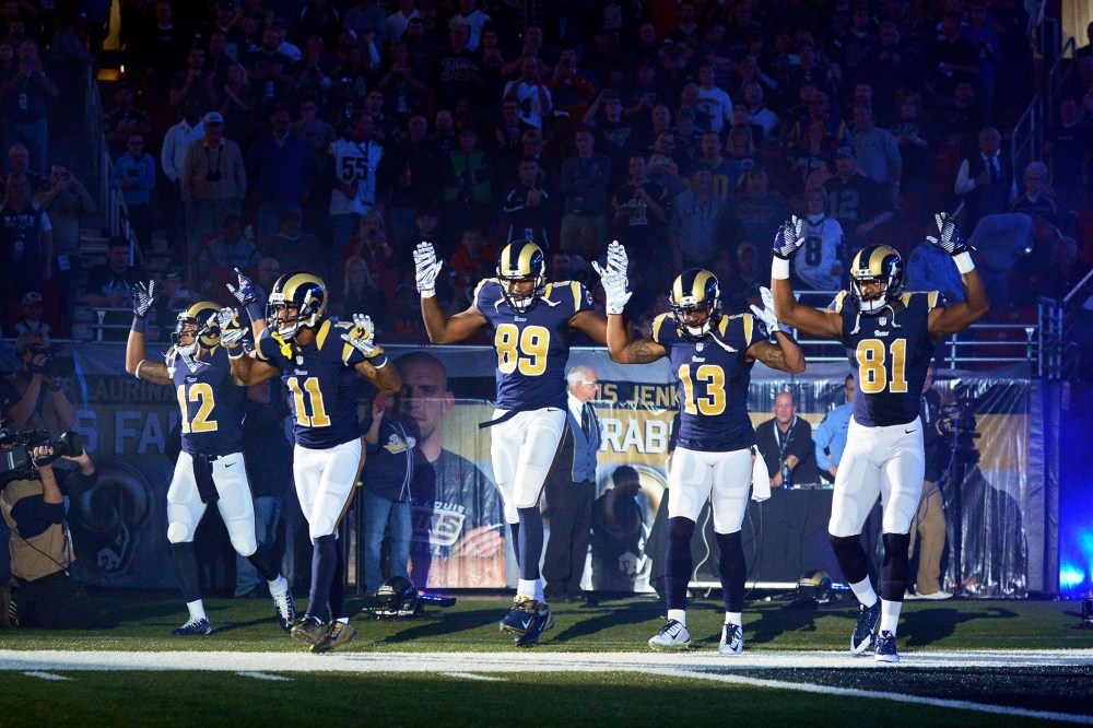 Players on the St. Louis Rams put their hands up to show support for Michael Brown before a game on Nov. 30, 2014 in St. Louis, Mo. (Photo by Jeff Curry/USA Today Sports/Reuters)