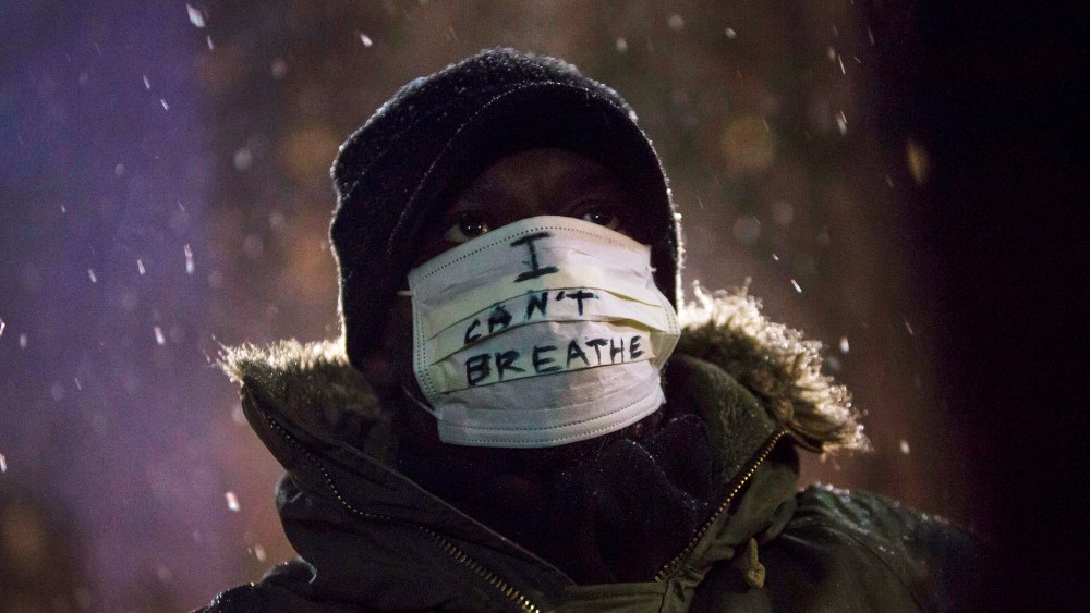 A man stands in falling snow following a news conference where members of Justice League NYC presented a list of demands at City Hall in New York, N.Y. on Dec. 10, 2014. (Photo by Andrew Kelly/Reuters)