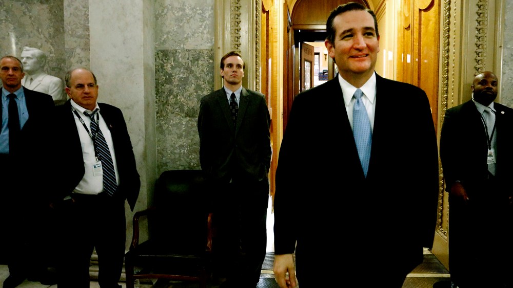 US Senator Ted Cruz smiles as he departs the Senate floor after it passed at $1.1 trillion spending bill at the US Capitol in Washington, Dec. 13, 2014. (Photo by Jonathan Ernst/Reuters)